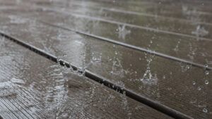 Rain on composite decking showing the grooved non-slip surface