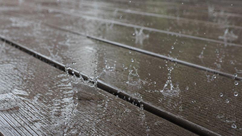 Rain on composite decking showing the grooved non-slip surface